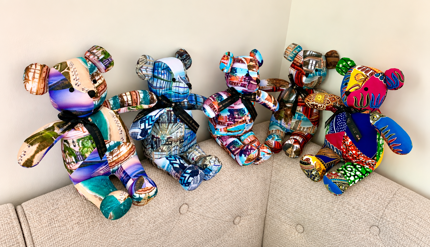 Five Four Seasons collectible destination bears arranged together on the back of a couch